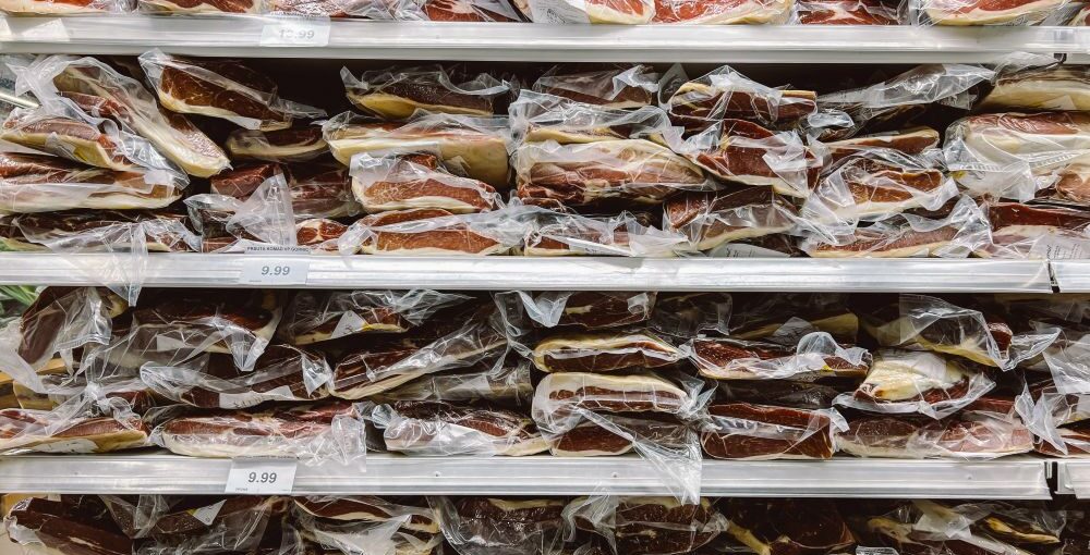 Vacuum-sealed cuts of beef stacked in a freezer, showing bulk meat storage and organization